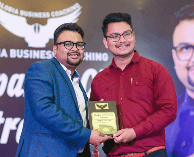 Vishal Saklani receiving an award at a business coaching event
