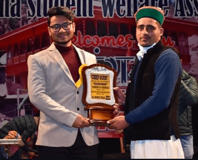 Vishal Saklani receiving a commemorative award at an event